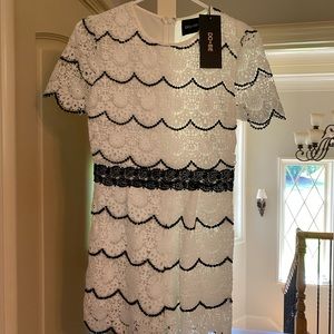 White short romper with black trim